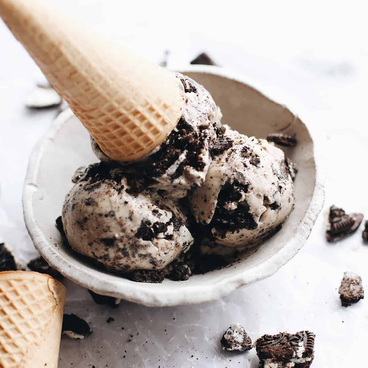 Oreo ice cream in a bowl with an ice cream cone