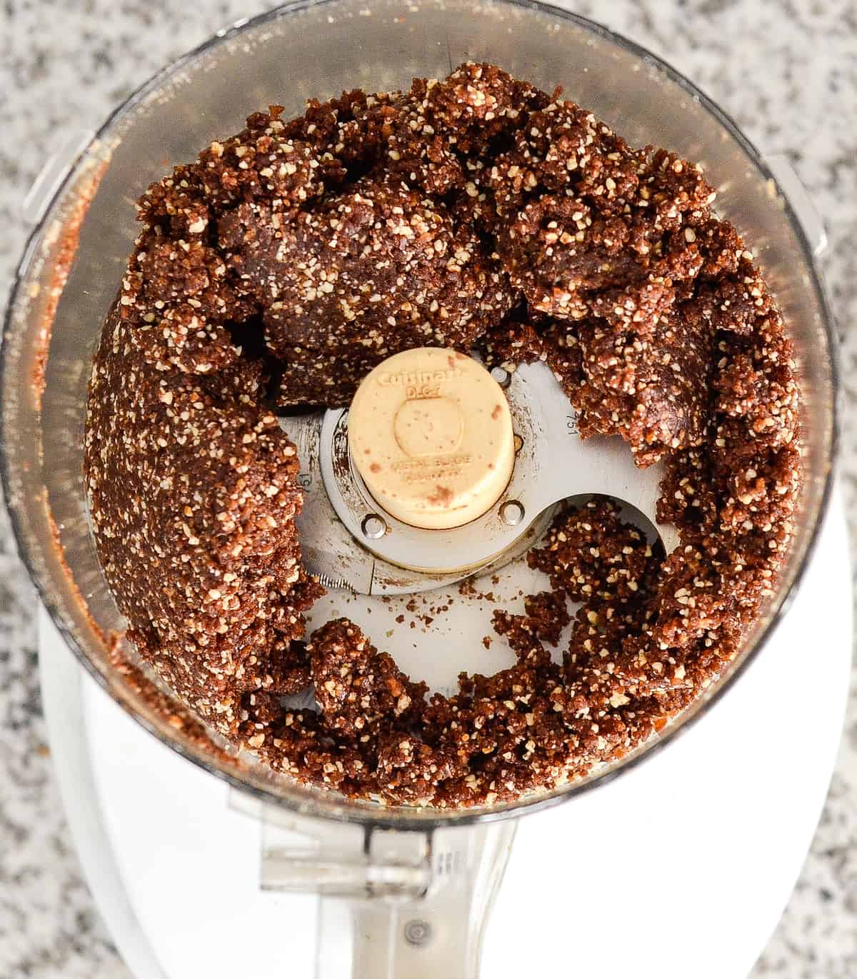 Overhead photo showing how to make protein balls in a food processor grinded. 