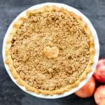 Overhead image of apple pie with small apple crust in center.