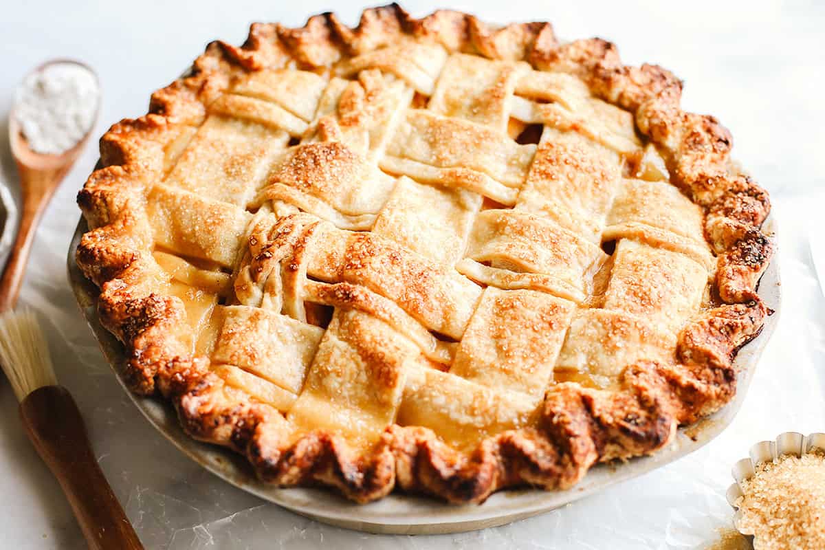 Peach pie with a lattice crust after being baked in a pie dish