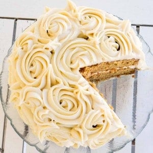 Overhead view of a Gluten-Free Carrot Cake with a piece cut out of it