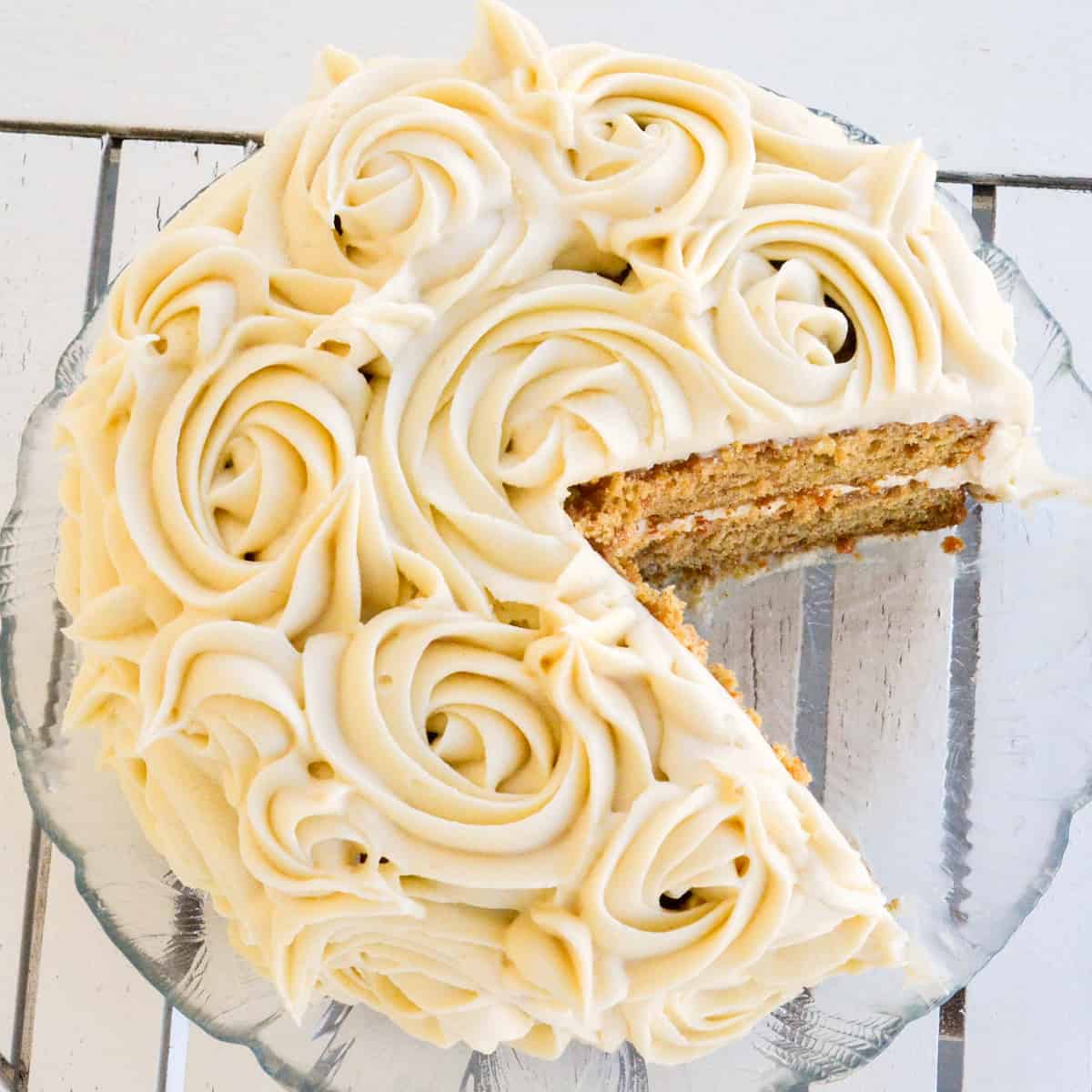 Overhead view of a Gluten-Free Carrot Cake with a piece cut out of it.