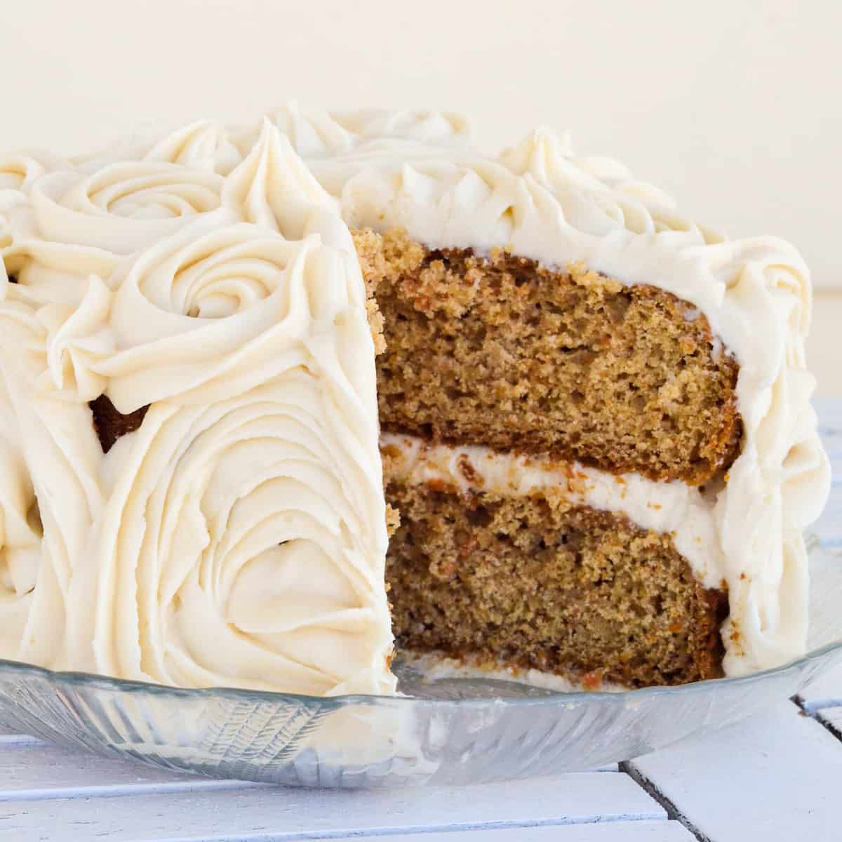 front view of a Gluten-Free Carrot Cake with a slice cut out of it