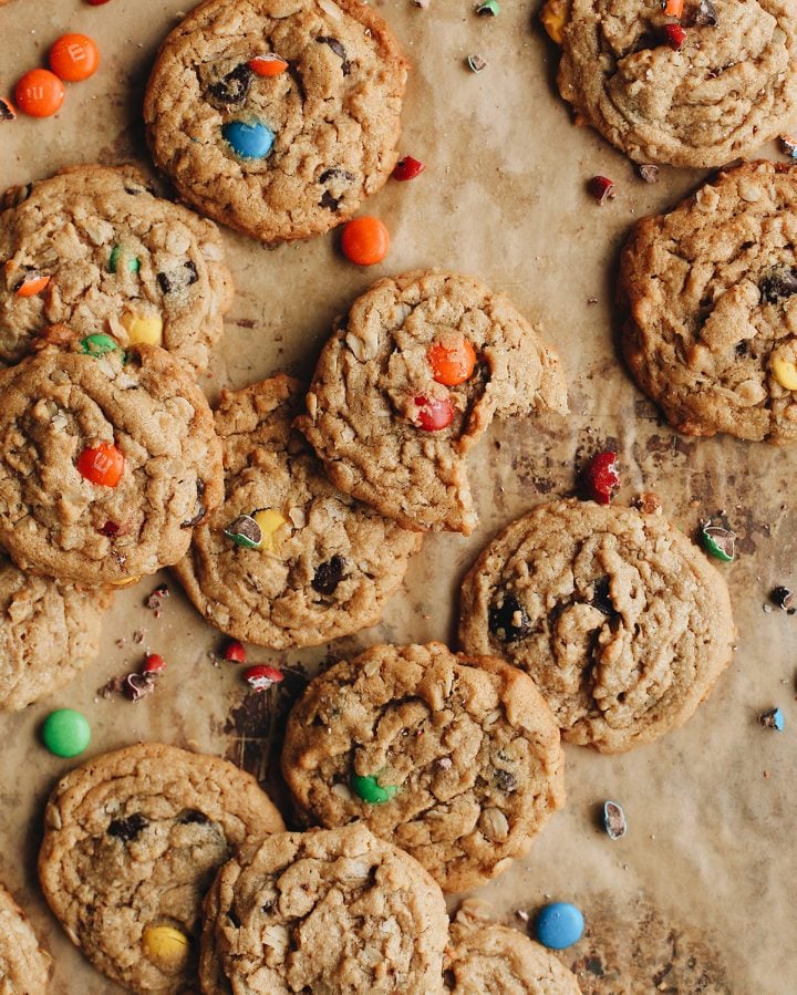 overhead view of 11 Monster Cookies, one with a bite taken out of it