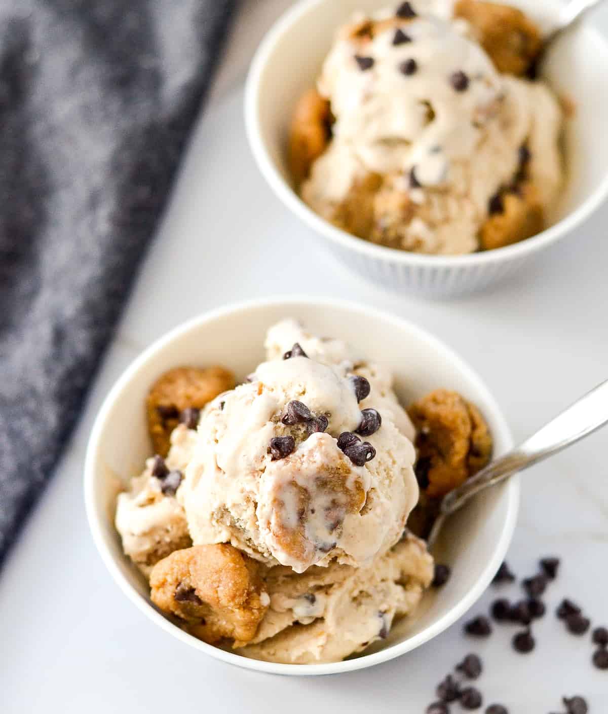 Overhead view of two bowls of cookie dough ice cream sprinkled with chocolate chips