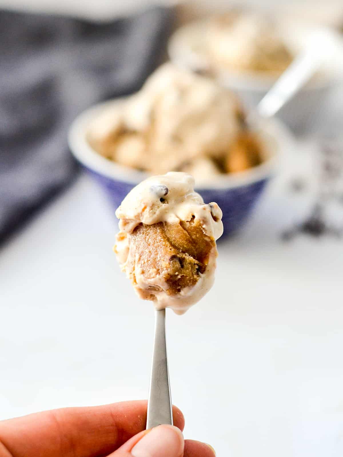 Up close view of a spoon of paleo cookie dough ice cream with a chunk of cookie dough