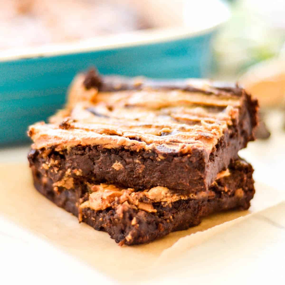 Front view of a stack of two Vegan Black Bean Brownies with peanut butter.