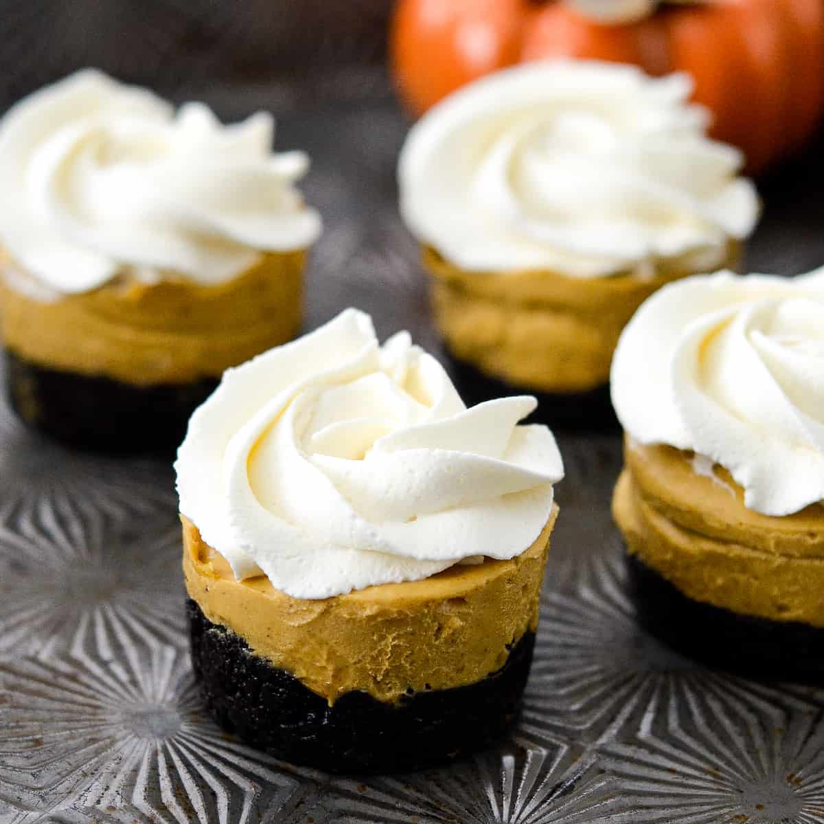 Front view of a No-Bake Vegan Pumpkin Pies with four others int he background.