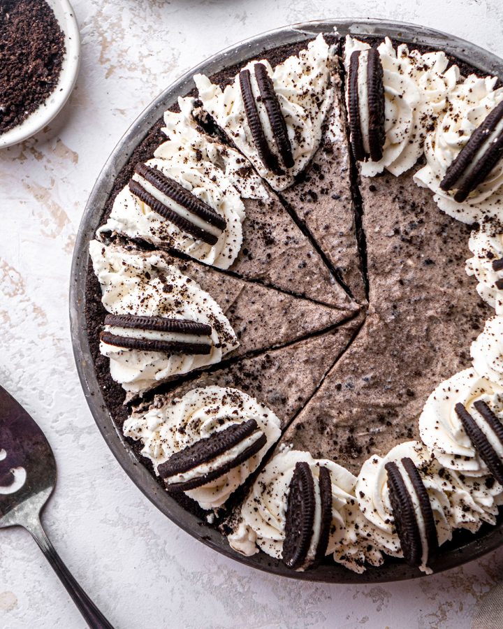 Overhead view of a decorated Oreo pie in a pie dish with four slices cut