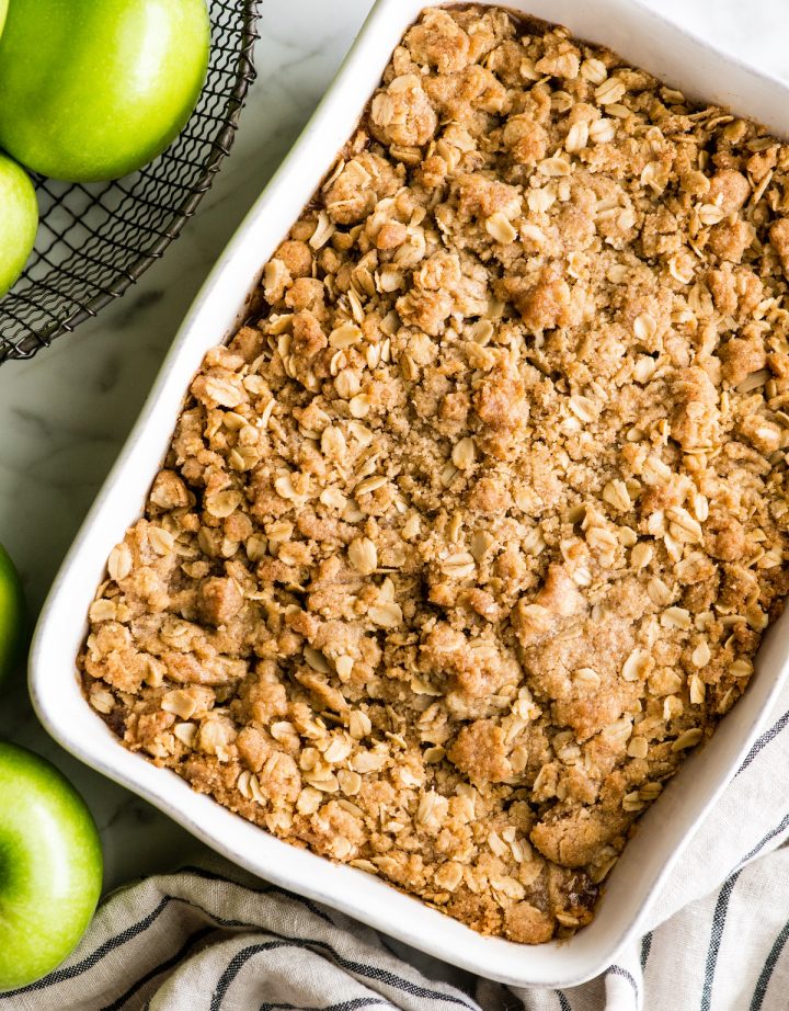 overhead view of a apple crisp in a white rectangular baking dish after it has been baked