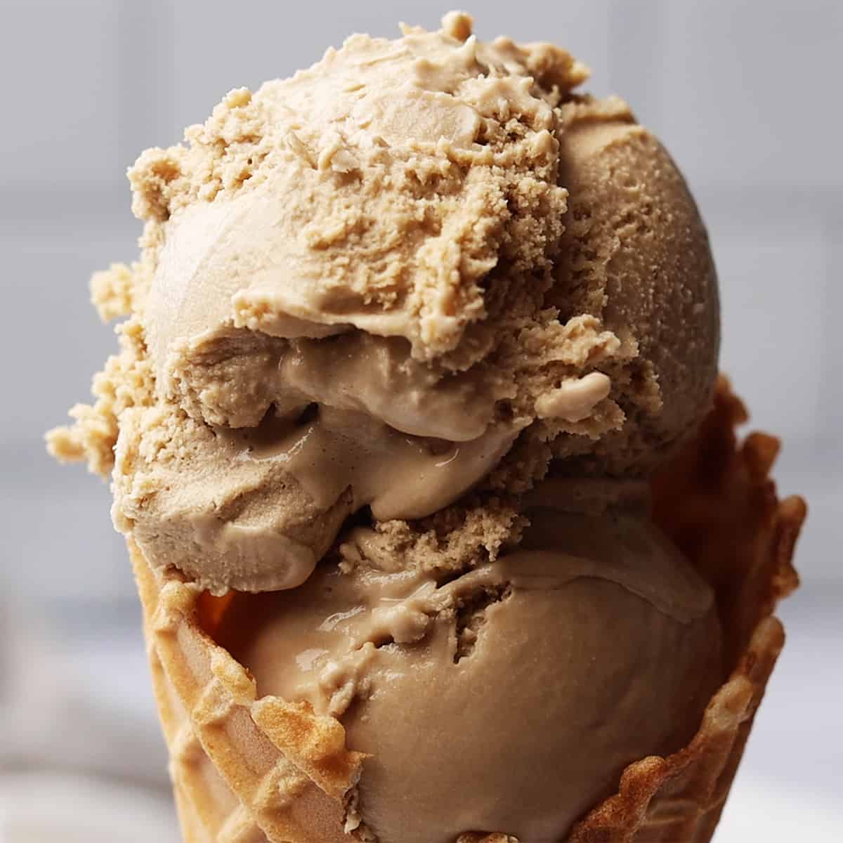 up close photo of two scoops of Coffee Ice Cream in a waffle cone