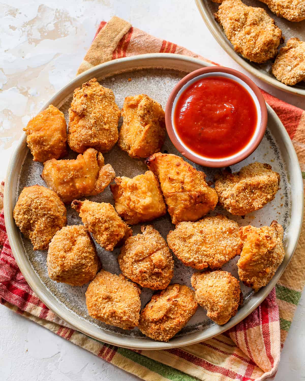 overhead view of Homemade Chicken Nuggets on a plate with a small bowl of ketchup