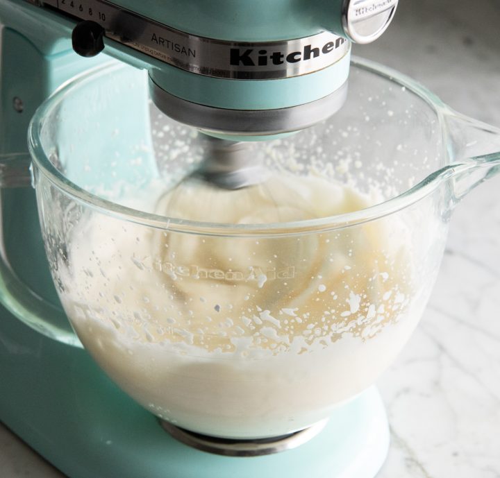 whipping cream being whipped in a standing mixer to make french silk pie