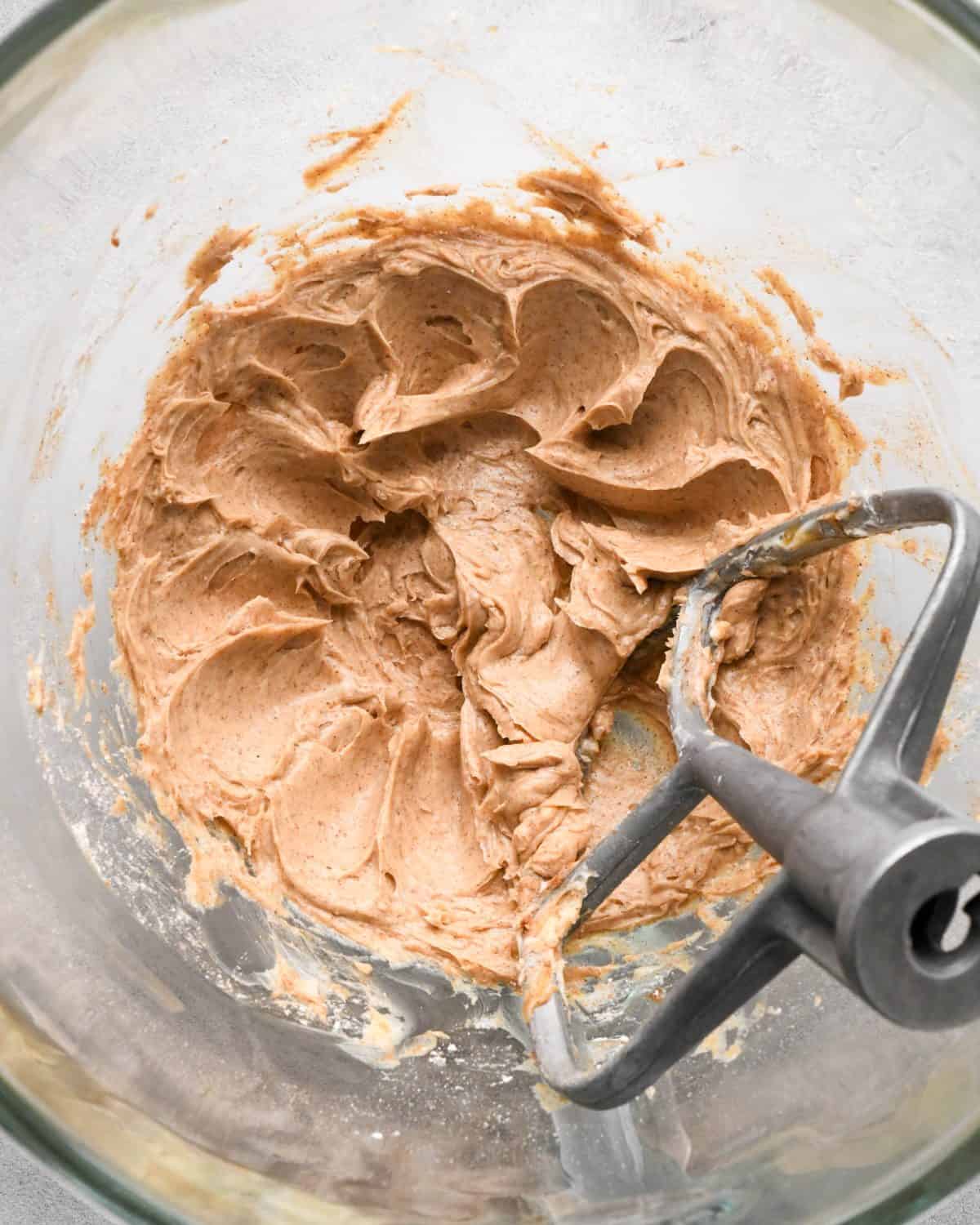 making homemade cinnamon honey butter to serve on top of these pumpkin pancakes - finished cinnamon butter in a glass bowl with the beater