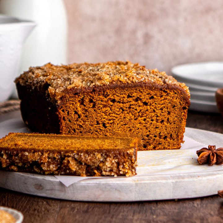 front view of a loaf of Healthy Pumpkin Bread with a slice cut out of it