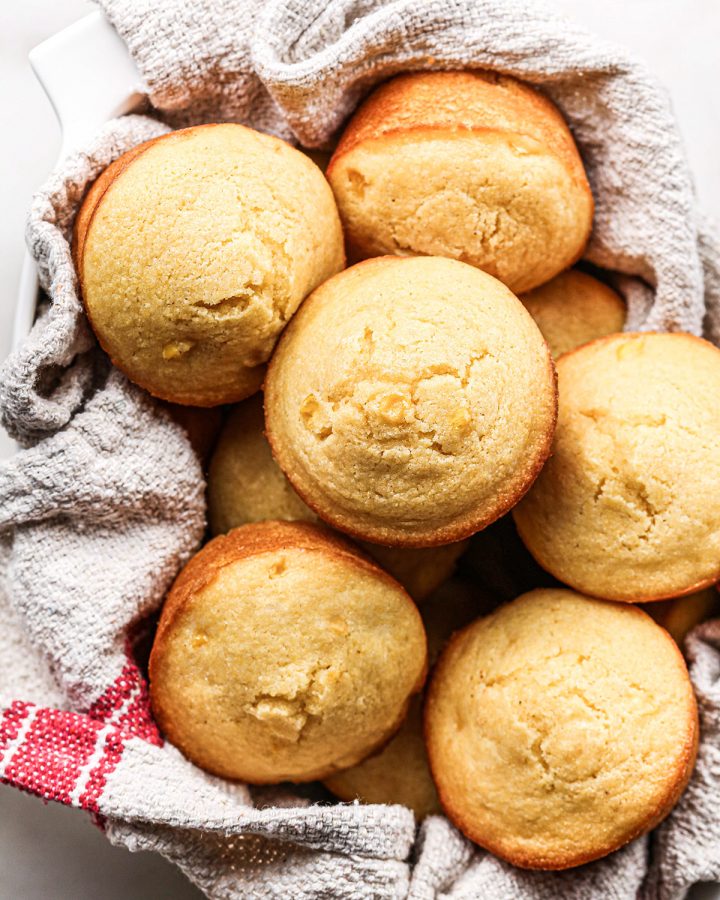 overhead view of 8 Cornbread Muffins in serving bowl lined with a towel