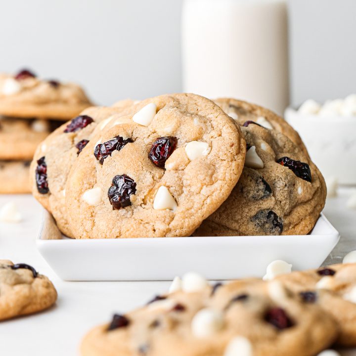 White Chocolate Cranberry Cookies on a plate with other cookies around it