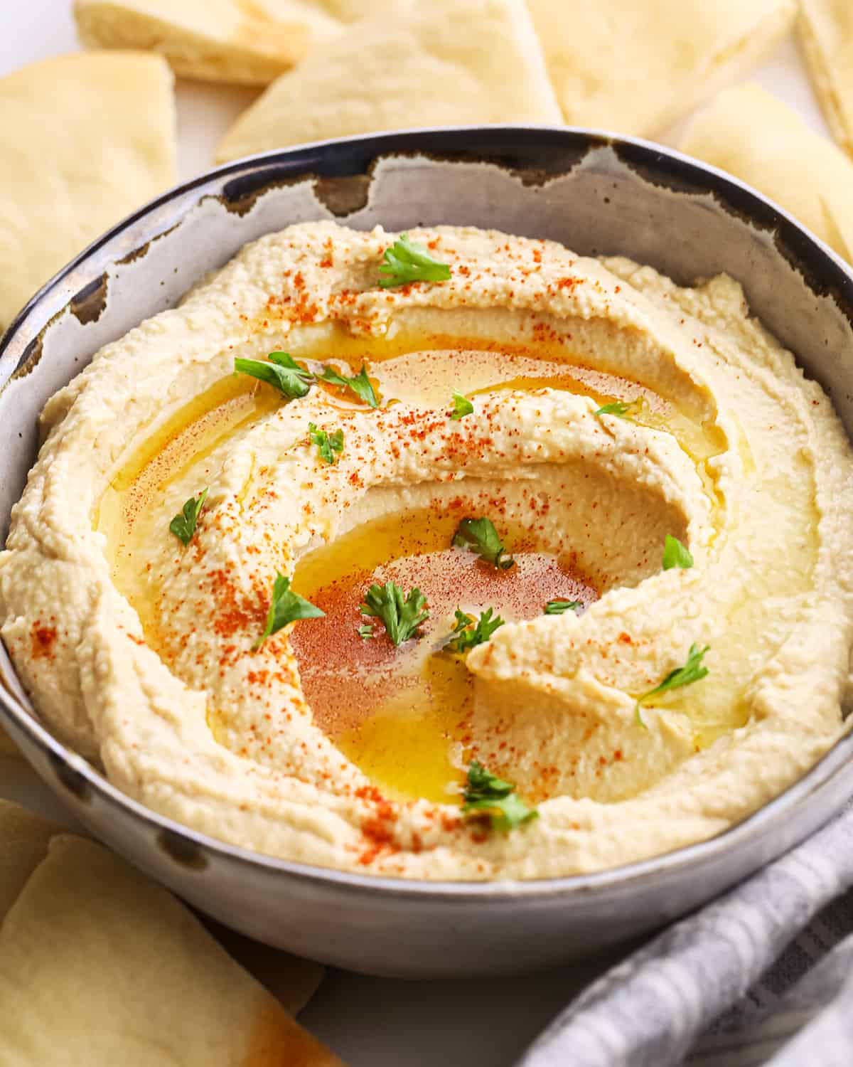 a bowl of Homemade Hummus topped with olive oil, paprika and parsley