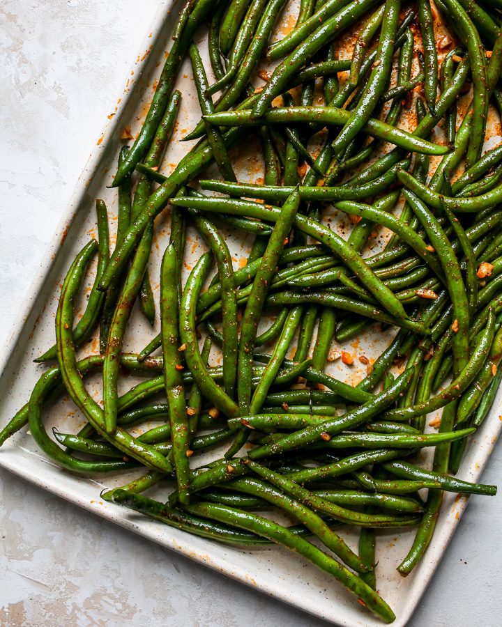 oven roasted green beans on a baking sheet after roasting