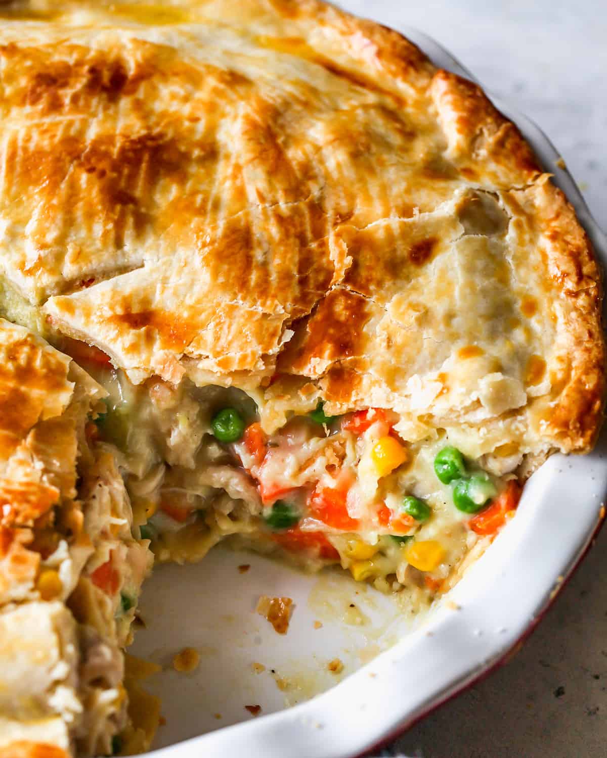 Turkey Pot Pie in a pie dish with a piece taken out of it