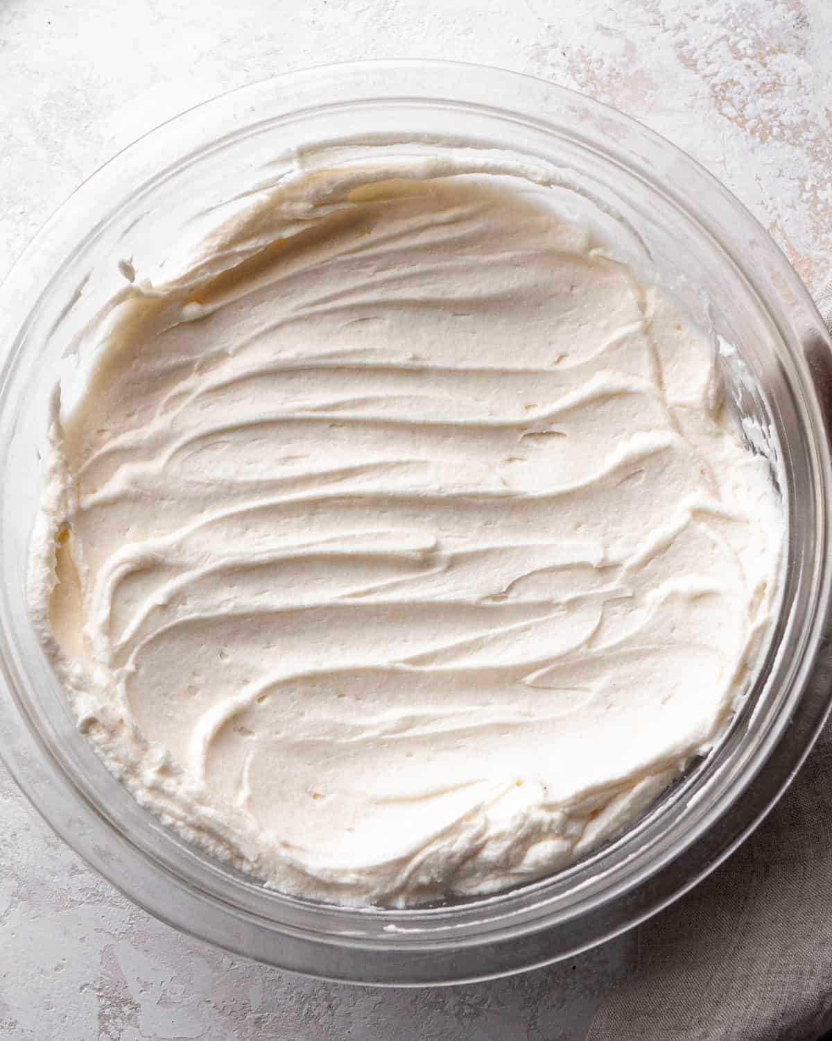 making Oreo pie recipe - filling mixture in a glass bowl on a gray surface