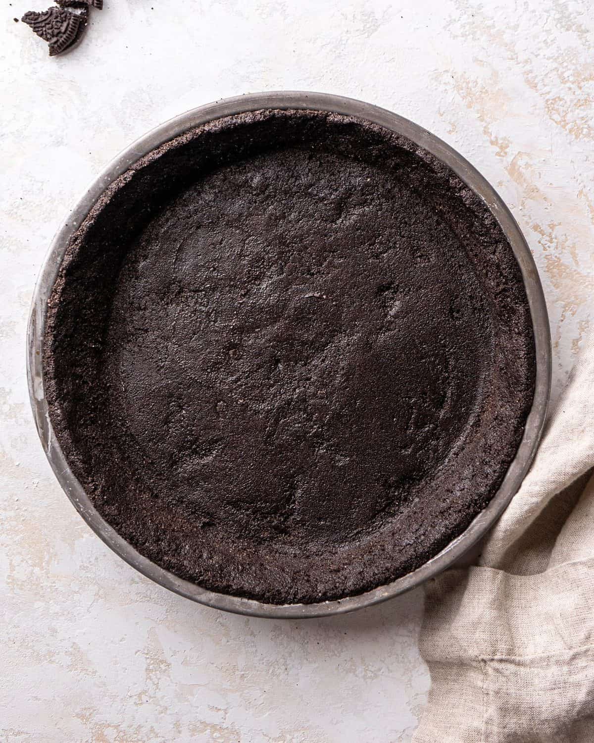making oreo pie recipe - Oreo crust in a baking dish before baking