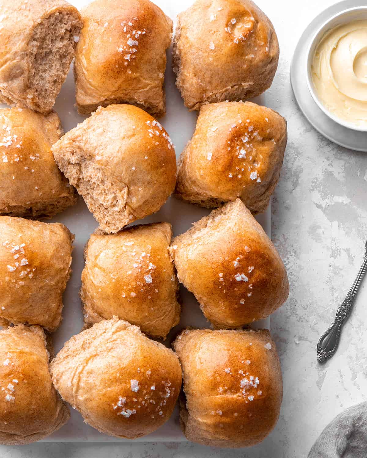 overhead view of 12 Whole Wheat Rolls with melted butter and sea salt on top