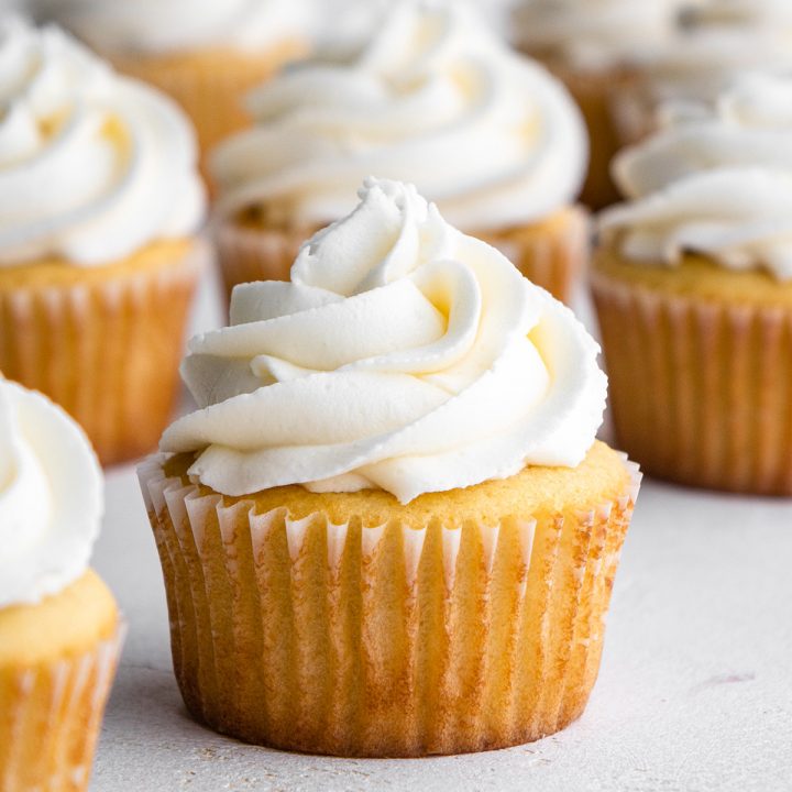 5 Vanilla Cupcakes topped with white frosting