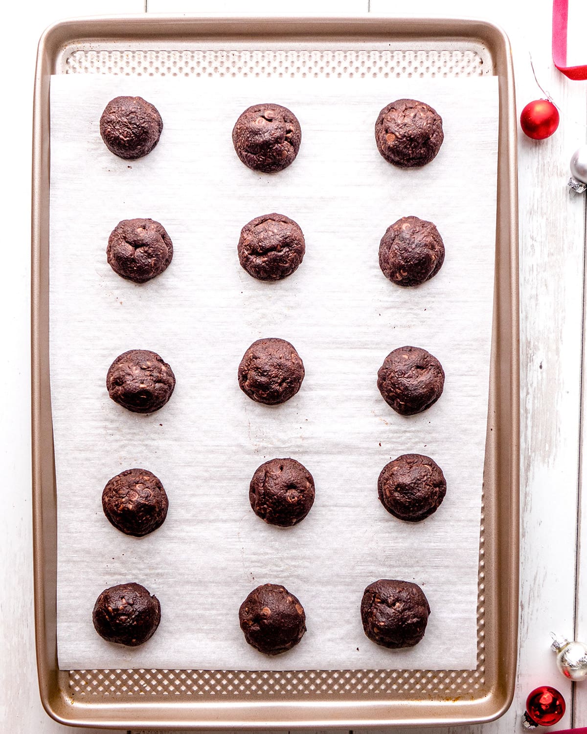 Chocolate Snowball cookies on a baking sheet after baking 