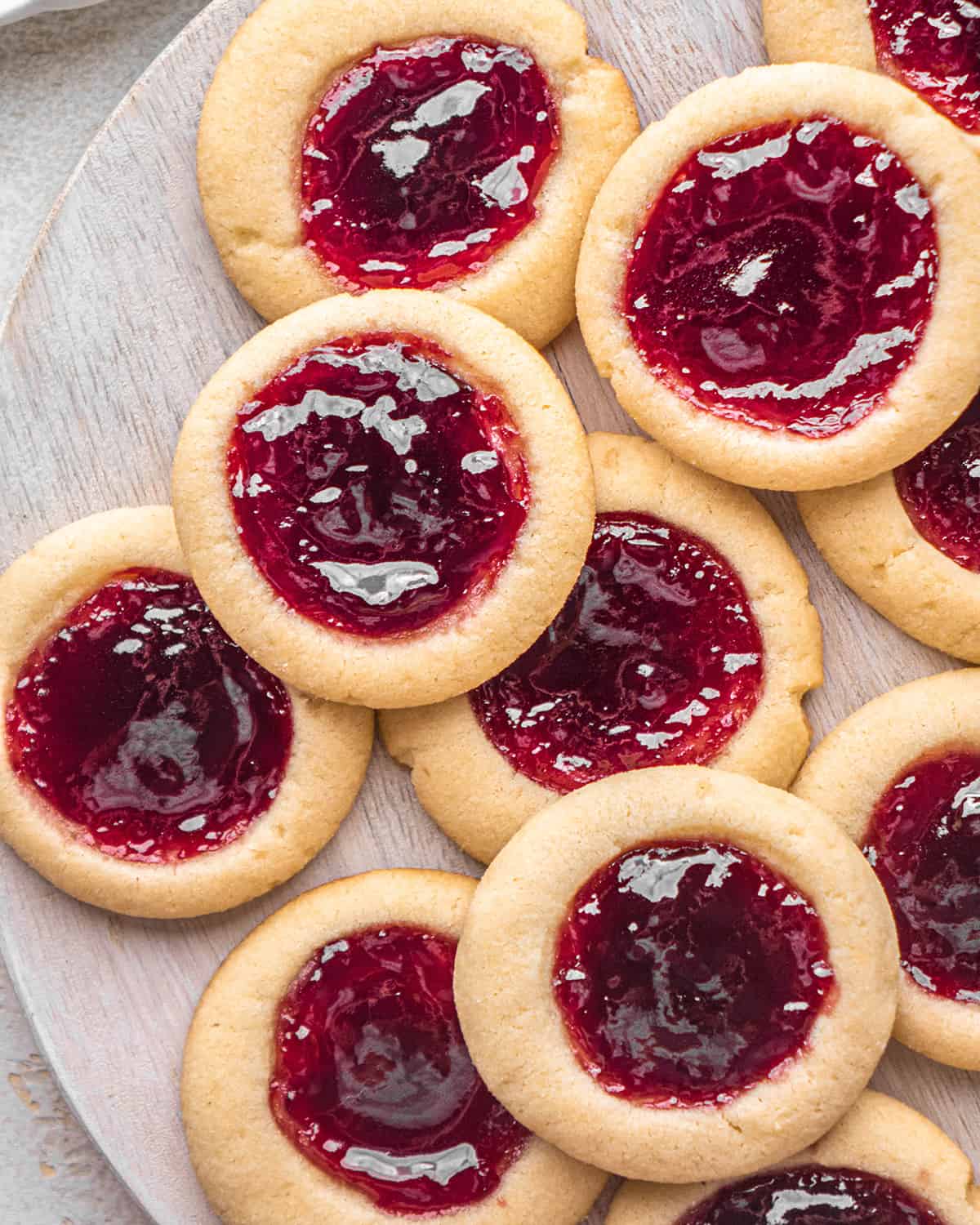 10 thumbprint cookies on a wooden serving tray