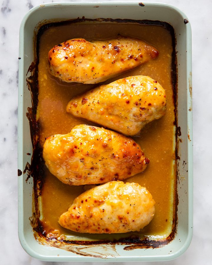 4 Honey Mustard Chicken breasts in a baking dish after baking