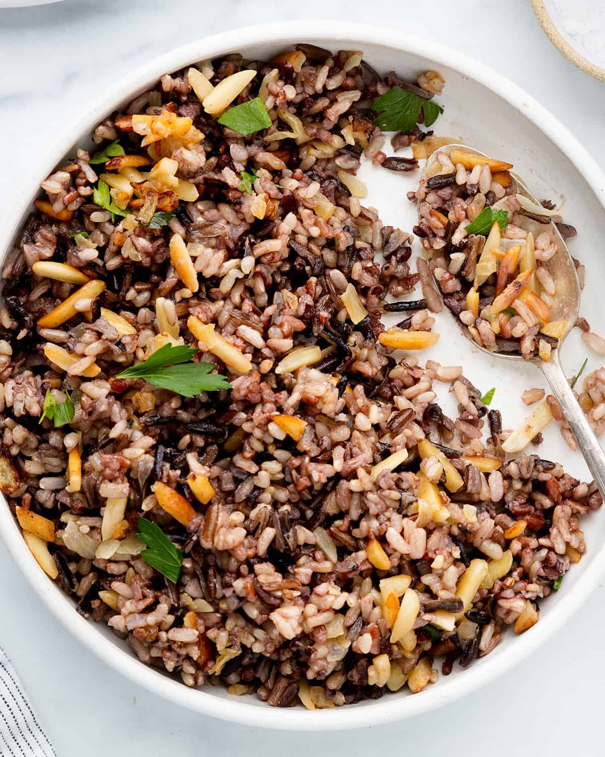 a bowl of Almond Wild Rice garnished with fresh parsley