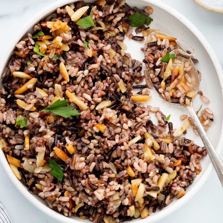 a bowl of Almond Wild Rice garnished with fresh parsley