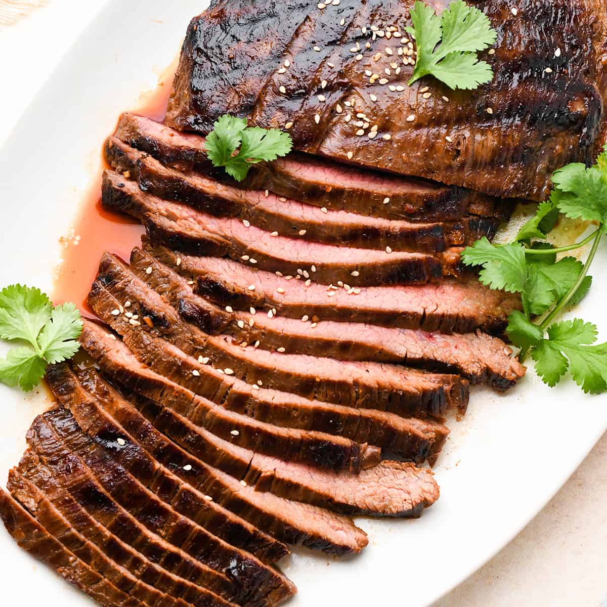 grilled flank steak sliced after soaking in an asian flank steak marinade