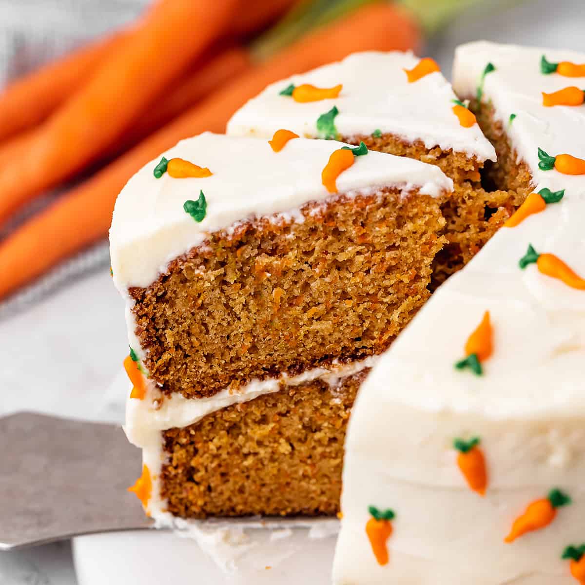 carrot cake with 2 slices cut out of it