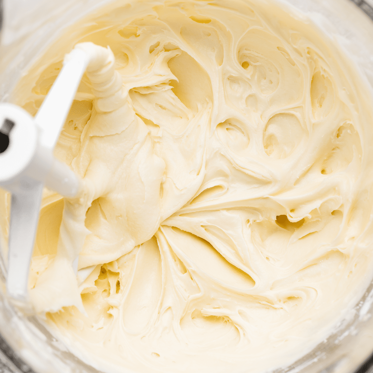 a mixing bowl of cream cheese frosting