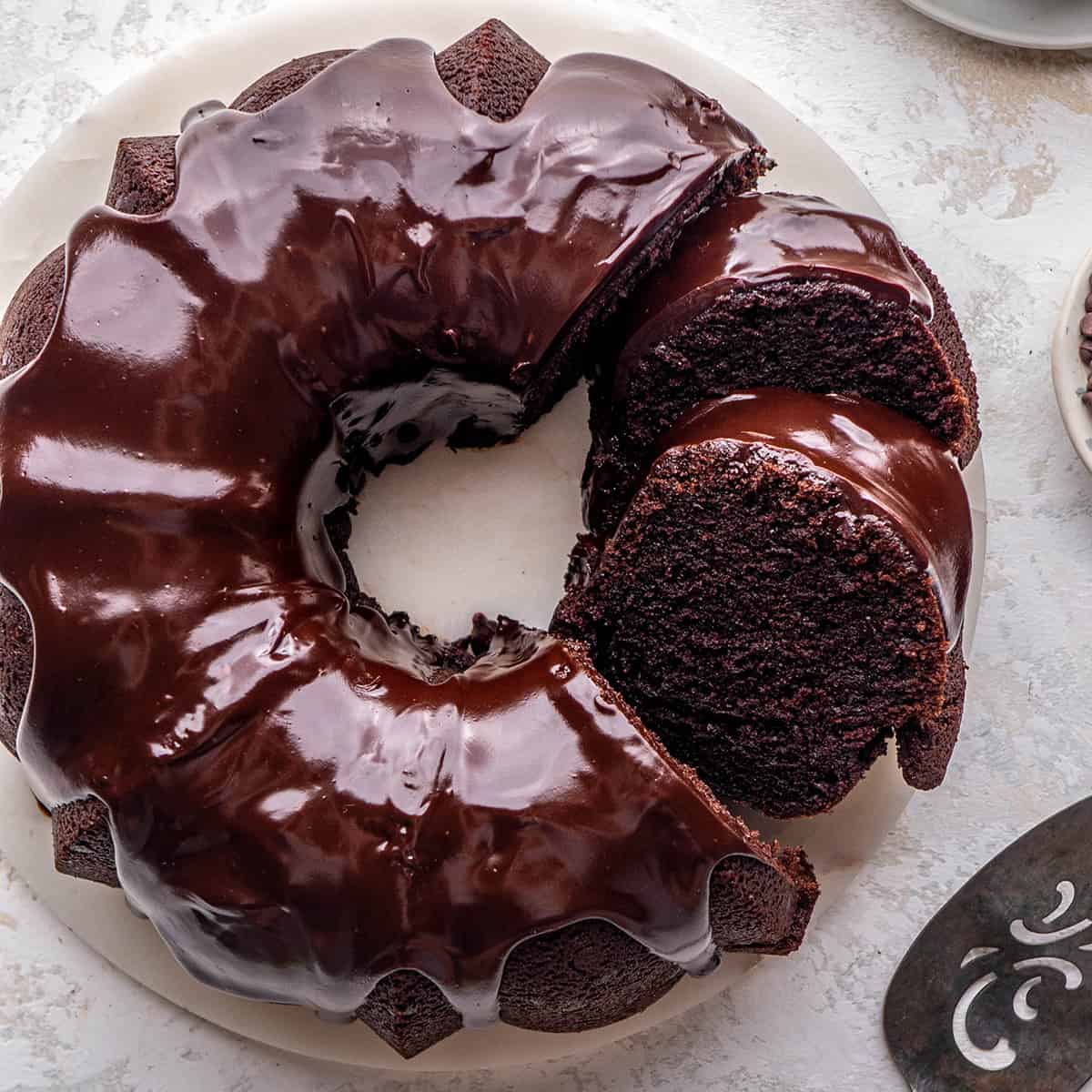 overhead view of a Chocolate Bundt Cake with a chocolate glaze and two slices cut out of it