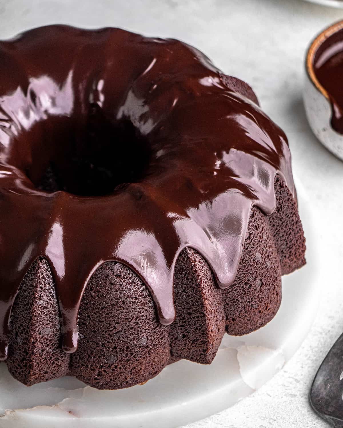 Chocolate Bundt Cake with a chocolate glaze on a cake plate 