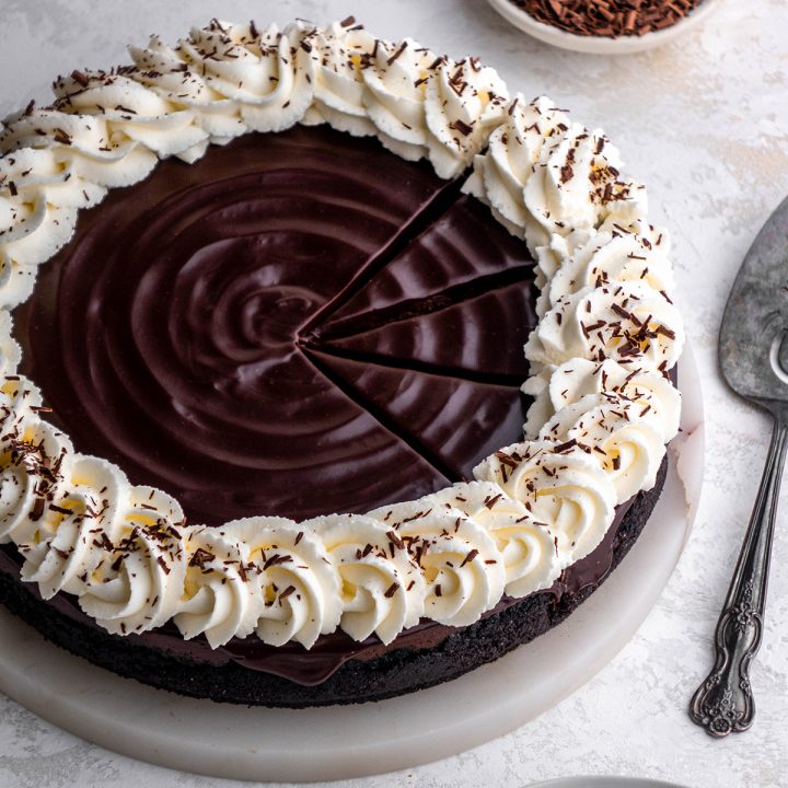a Chocolate Cheesecake with three slices cut