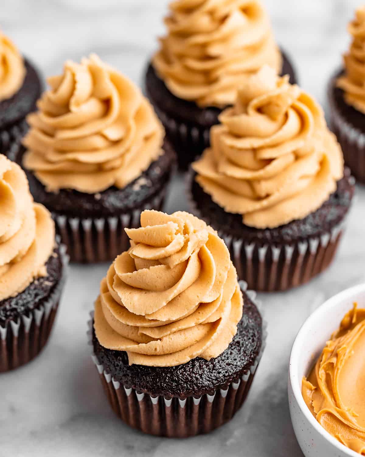 7 chocolate cupcakes with Peanut Butter Frosting on top 