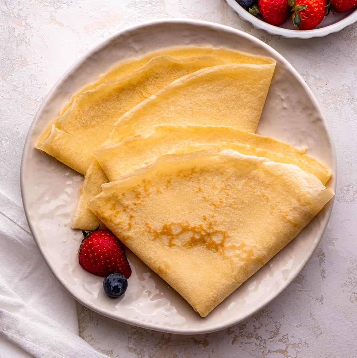 3 crepes on a plate folded into triangles
