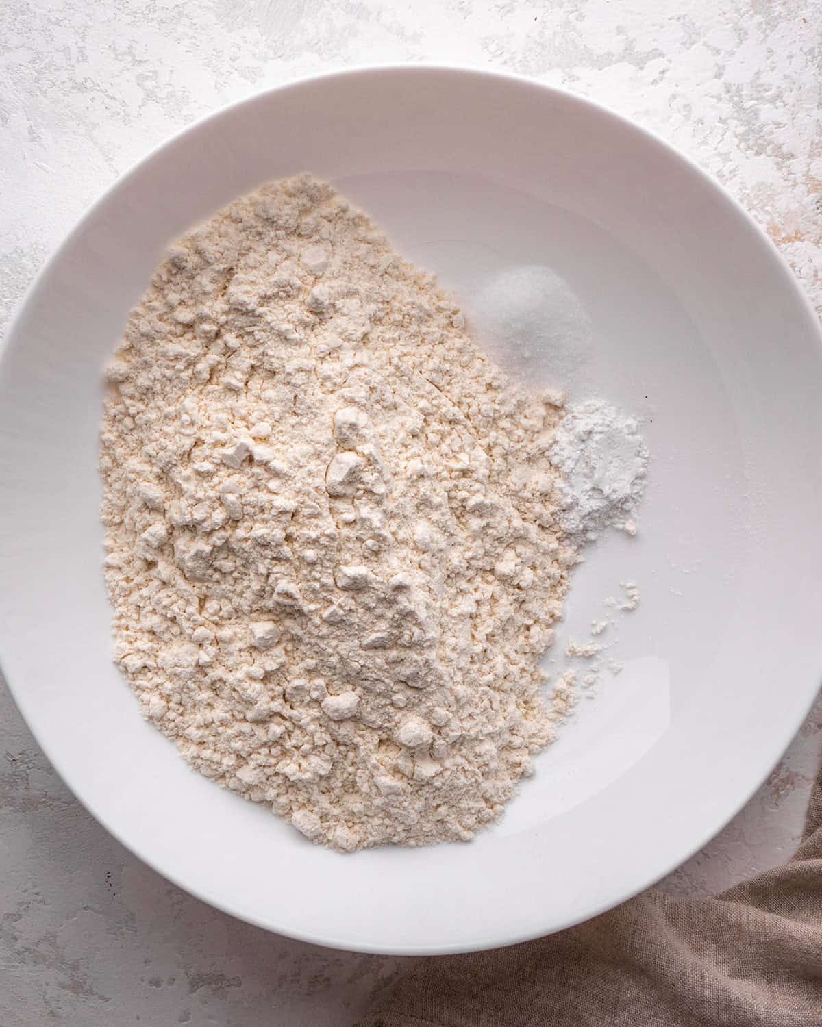 how to make blondies - flour, baking powder and salt in a white bowl before mixing