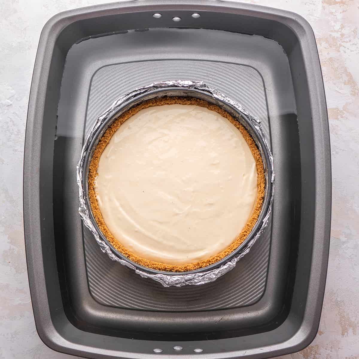 cheesecake in a water bath before baking