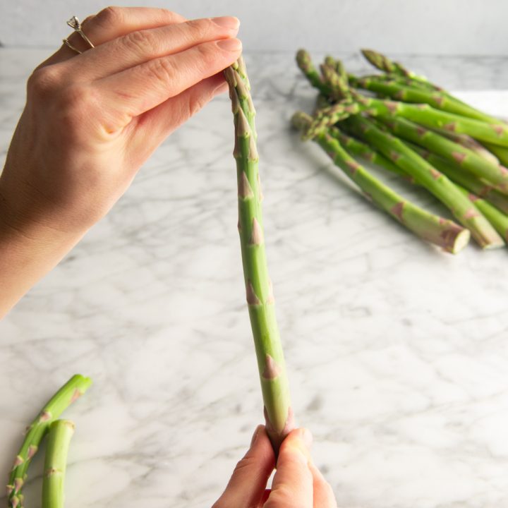 photo showing How to Trim Asparagus - holding it by two ends 