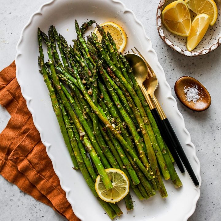 Oven Roasted Asparagus on a white serving plate 