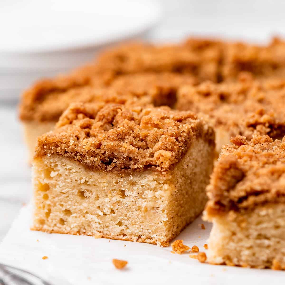 a piece of Cinnamon Coffee Cake surrounded by the rest of the cake