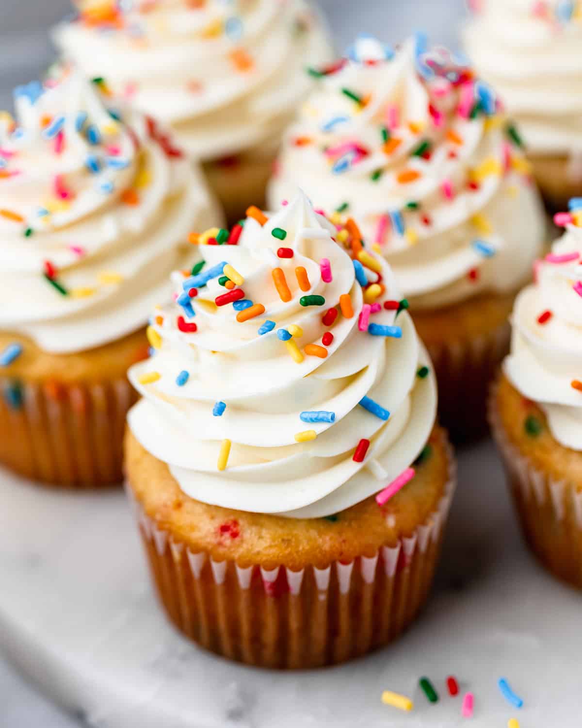 5 frosted funfetti cupcakes with sprinkles