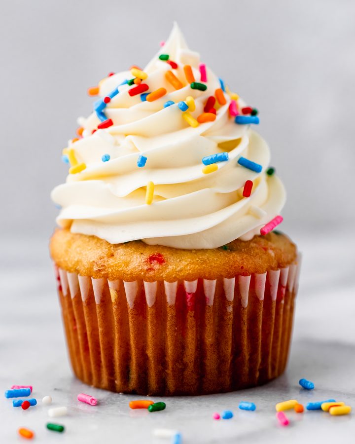 one funfetti cupcake with vanilla frosting and sprinkles