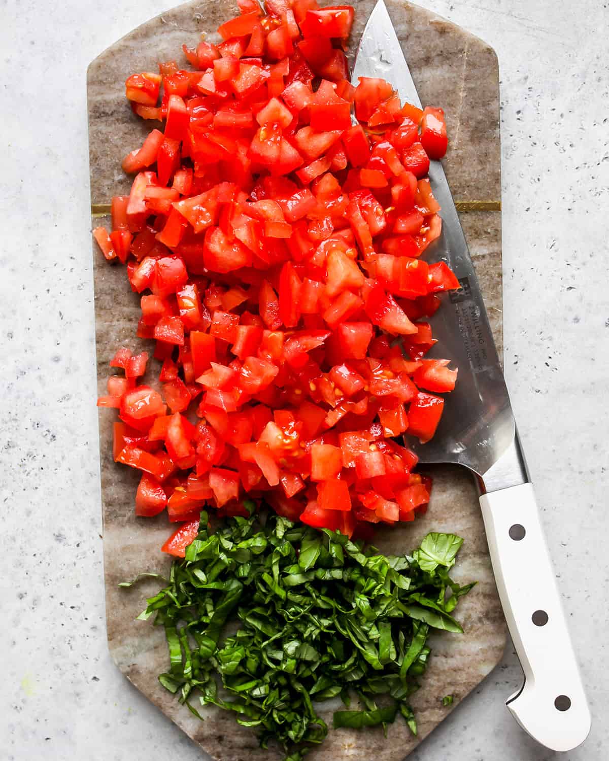 photo showing How to Make Bruschetta - dicing tomatoes and cutting basil