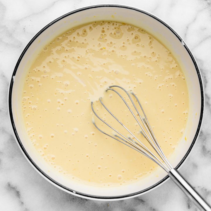 lemon pie filling being whisked together in a bowl.